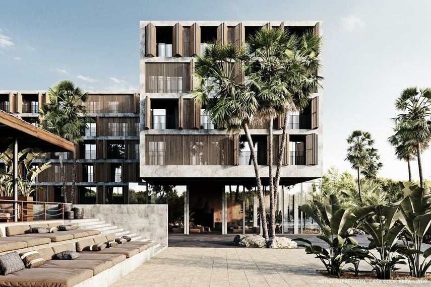 Low whitewashed buildings set around an open courtyard with dry planting