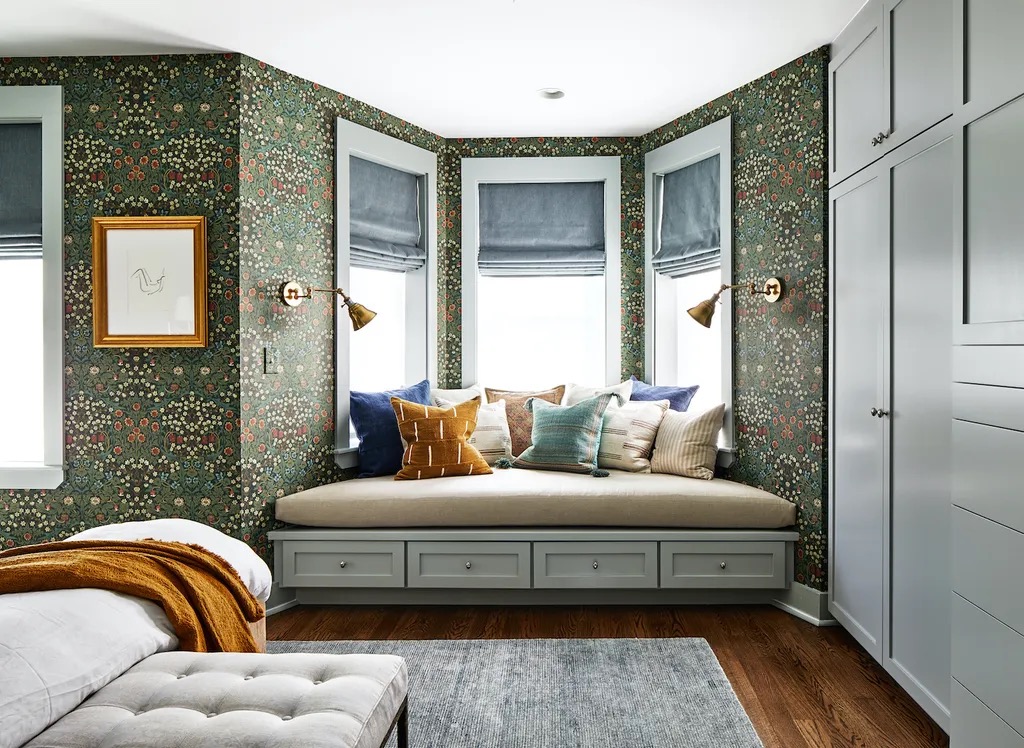 Hotel lounge with tall windows, seating and hung work on the walls