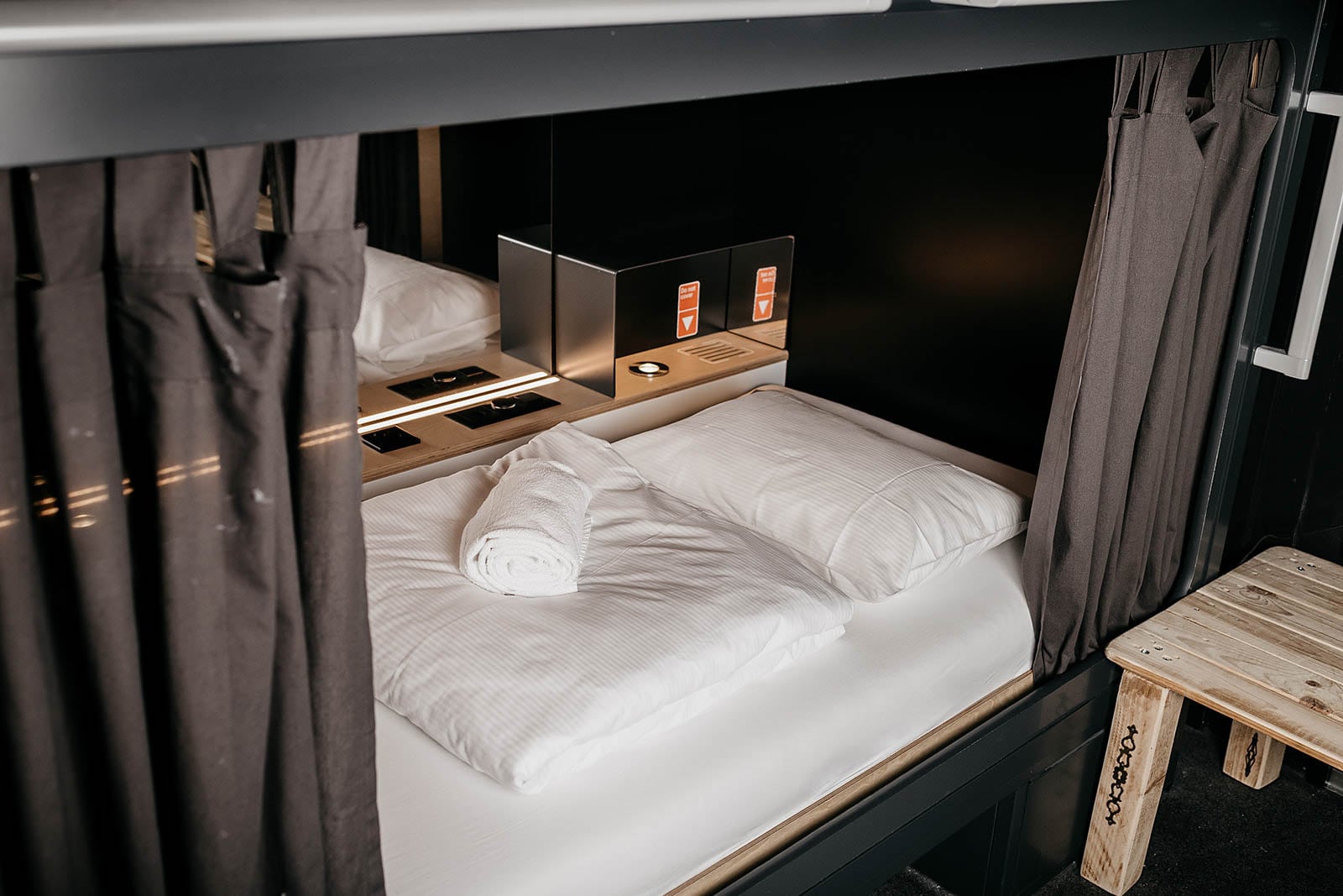 Narrow interior corridor lined with stacked compact sleeping berths