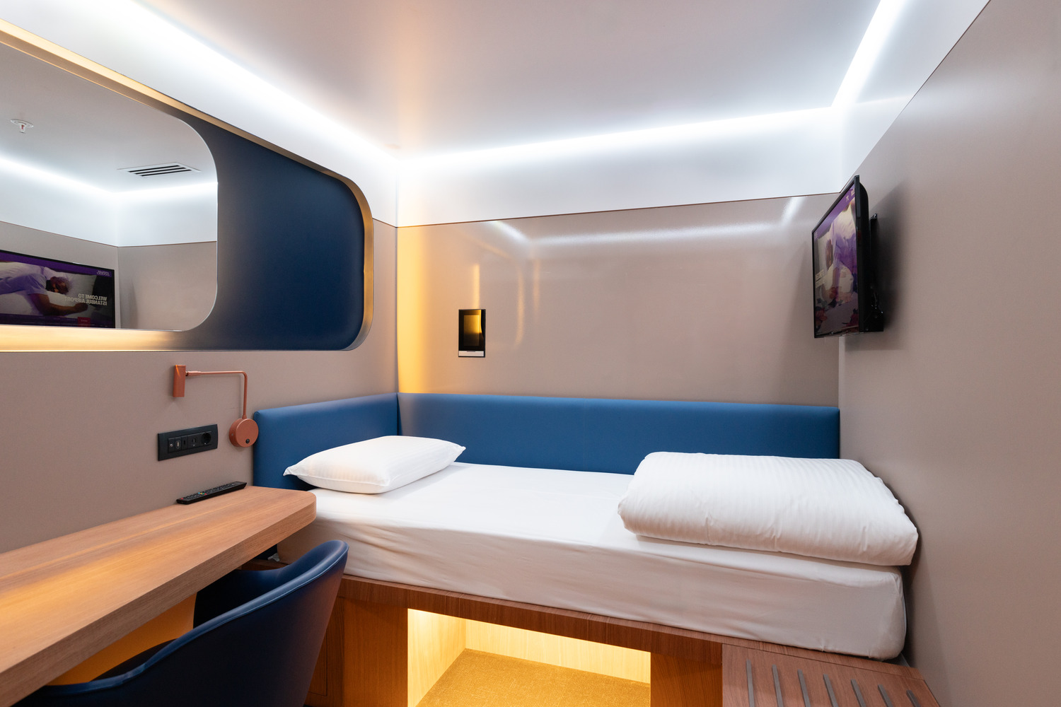 Compact windowless cabin with an adjustable bed and a work surface